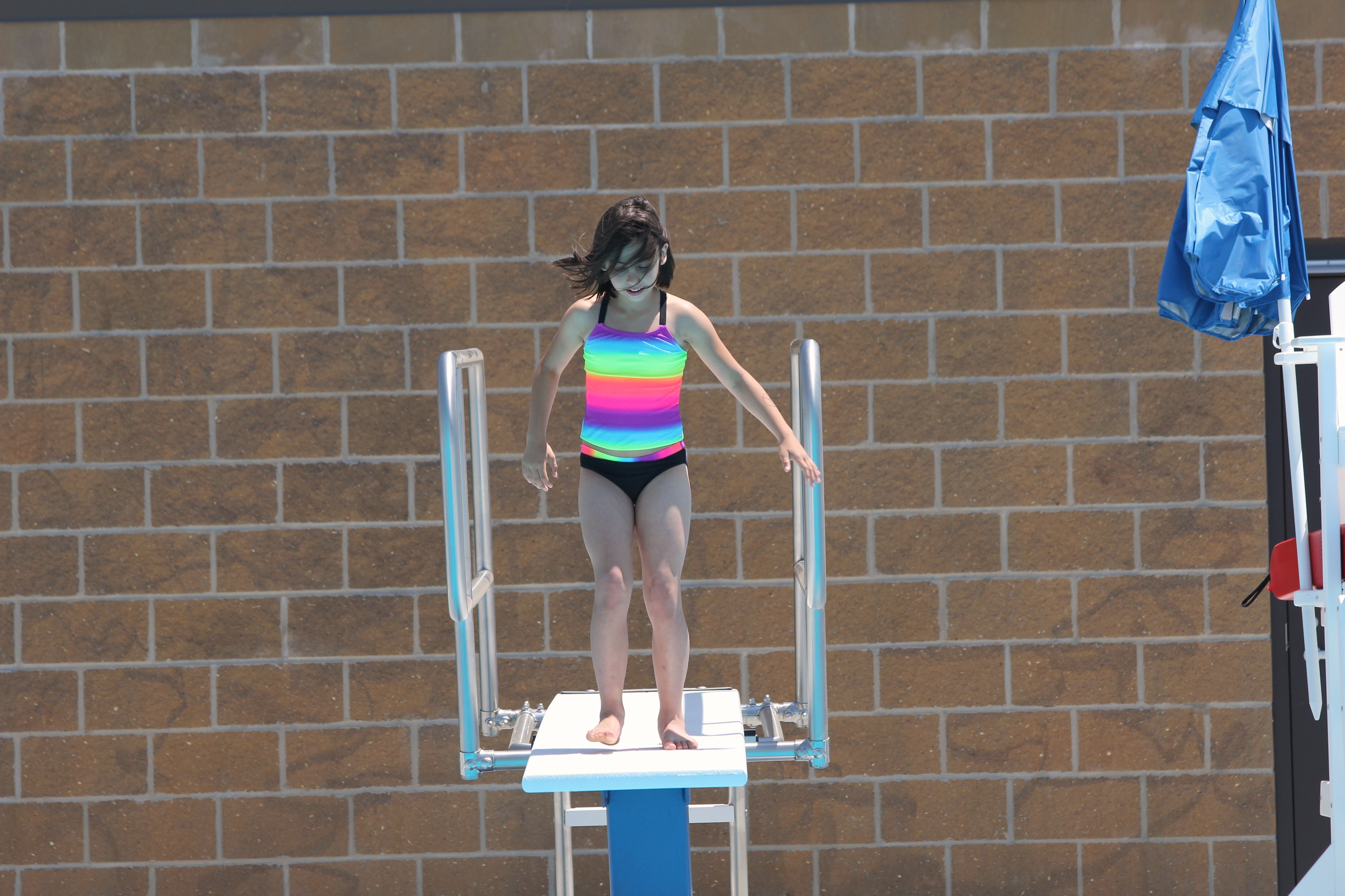 Getting ready to go off the diving board.